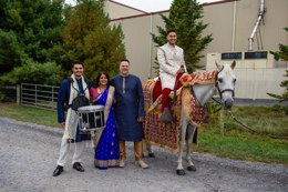 Groom with baraat horse and family